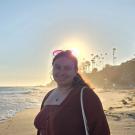 A woman on a beach at sunset 
