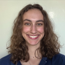 photograph of Kari - curly brown hair, white/tan skin, hazel eyes